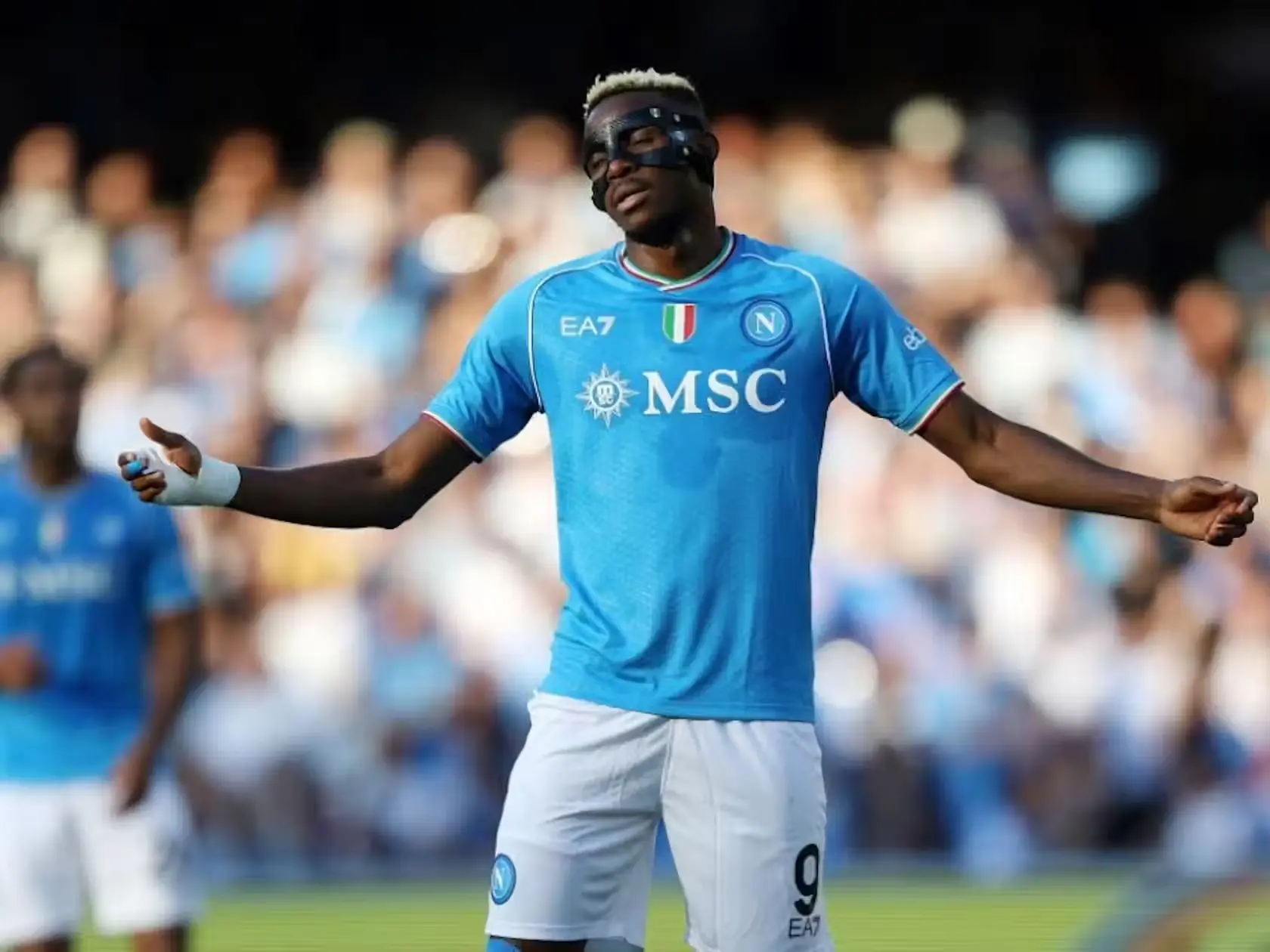 Victor Osimhen in Napoli Jersey with Protective Mask, Expressing on the Field